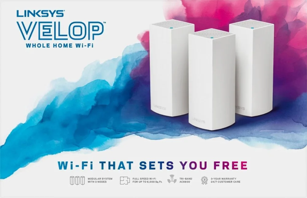 Linksys Velop mesh Wi-Fi towers arranged on a tabletop.