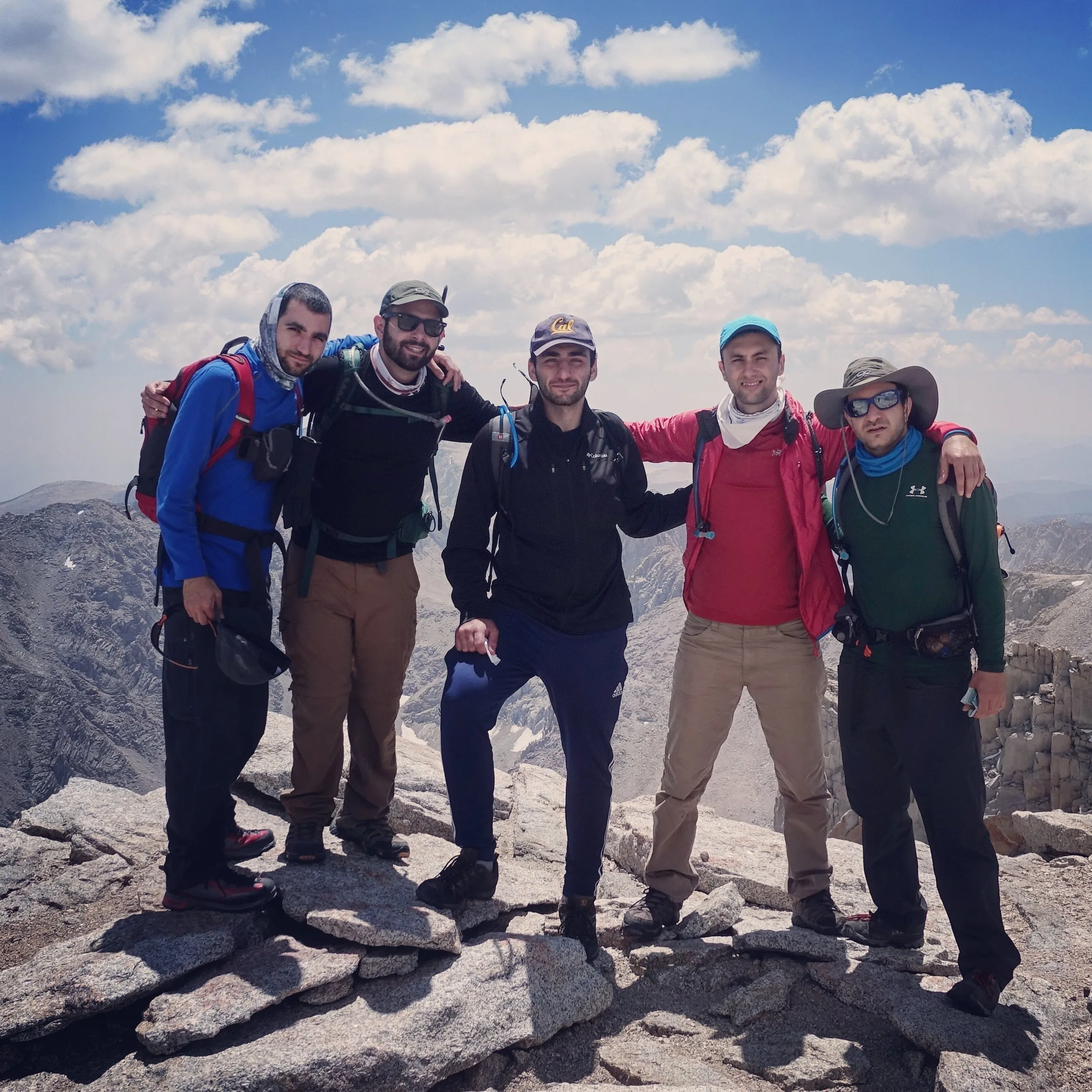 Group of hikers celebrating at the Mt. Whitney summit hut.